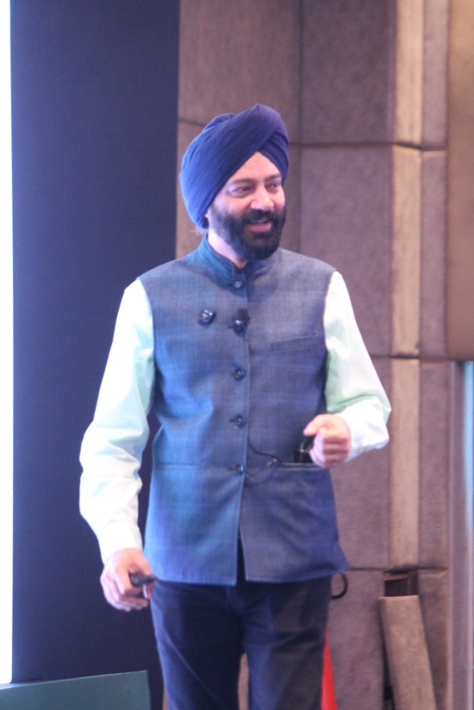 Harjeet Khanduja speaking on stage